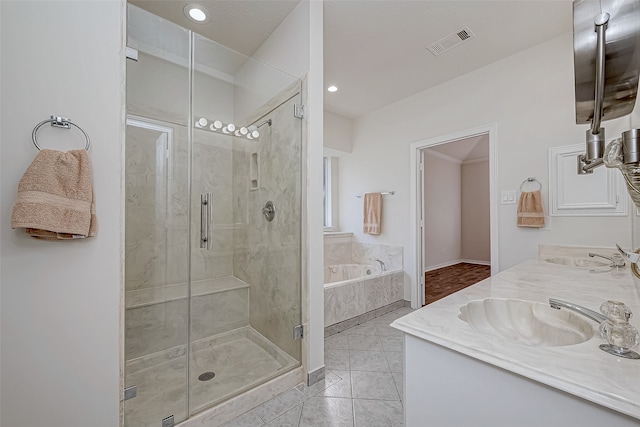 bathroom with tile patterned flooring, vanity, and separate shower and tub