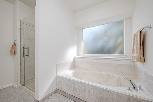 bathroom featuring separate shower and tub