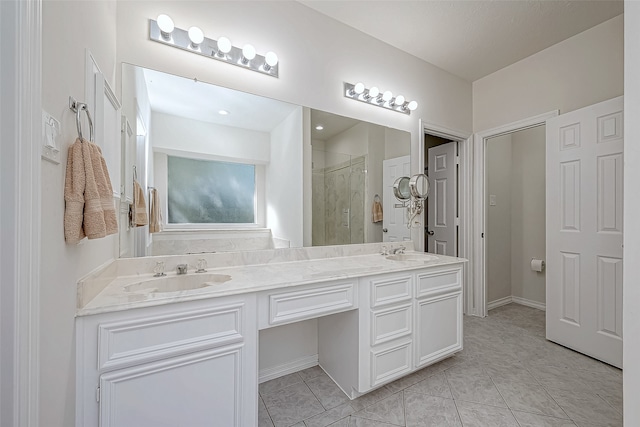 bathroom with tile patterned floors, vanity, and a shower with door