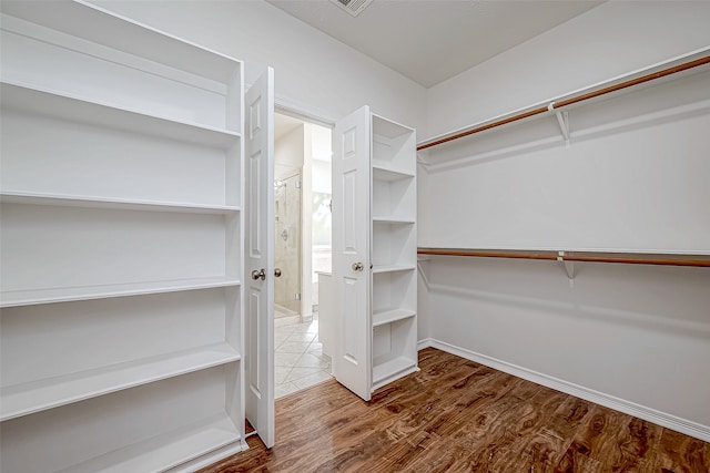 spacious closet with wood-type flooring