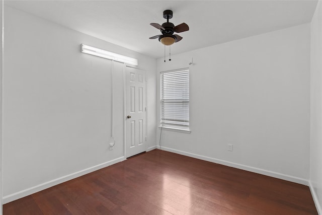 spare room featuring dark hardwood / wood-style flooring and ceiling fan