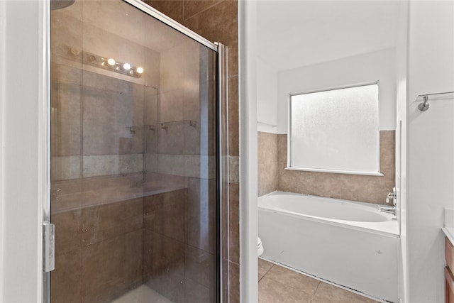 full bathroom featuring tile patterned flooring, vanity, separate shower and tub, and toilet