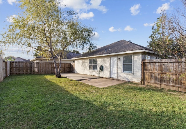 back of property featuring a patio area and a yard