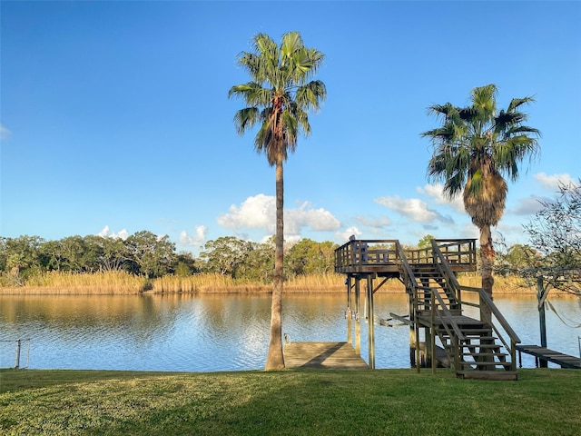 dock area with a water view and a lawn