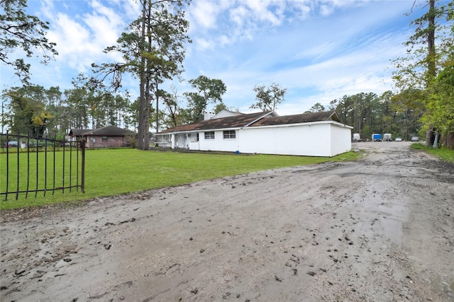 view of side of home featuring a yard