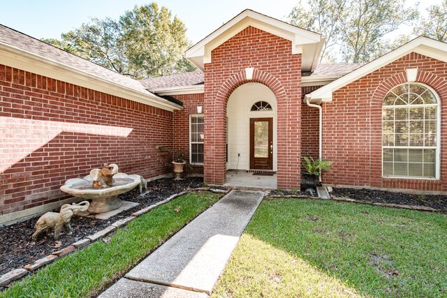 206 Private Road 635, Dayton, TX 77535 - entrance to property featuring brick siding, a shingled roof, and a lawn