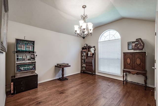 misc room featuring dark hardwood / wood-style flooring, lofted ceiling, and a chandelier