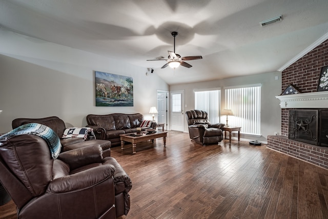 living room featuring ceiling fan, wood-type flooring, vaulted ceiling, and a brick fireplace