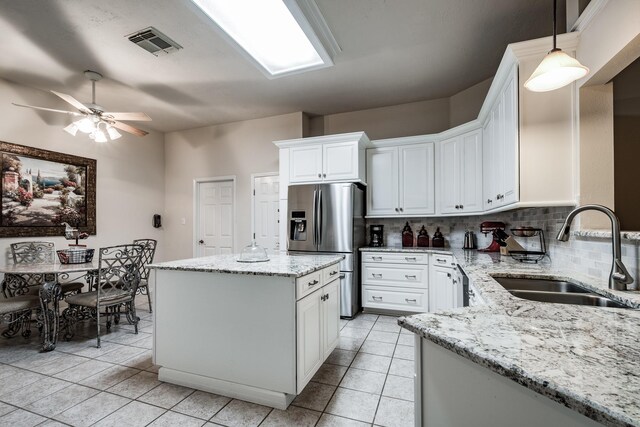 206 Private Road 635, Dayton, TX 77535 - kitchen featuring a sink, stainless steel fridge with ice dispenser, backsplash, light tile patterned floors, and a ceiling fan