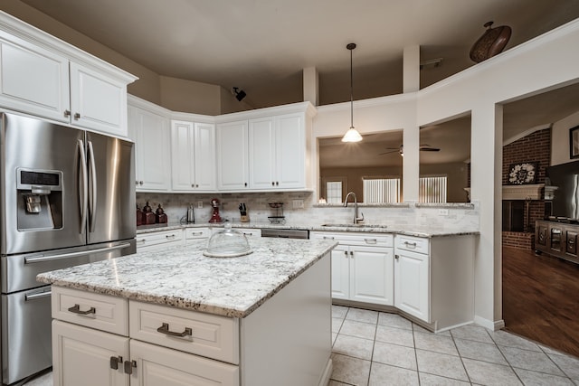 kitchen with white cabinets, sink, light tile patterned floors, and stainless steel appliances