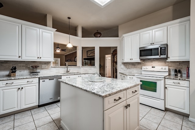 kitchen featuring appliances with stainless steel finishes, white cabinetry, ceiling fan, and pendant lighting