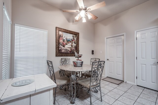 dining area with ceiling fan, light tile patterned floors, and a healthy amount of sunlight