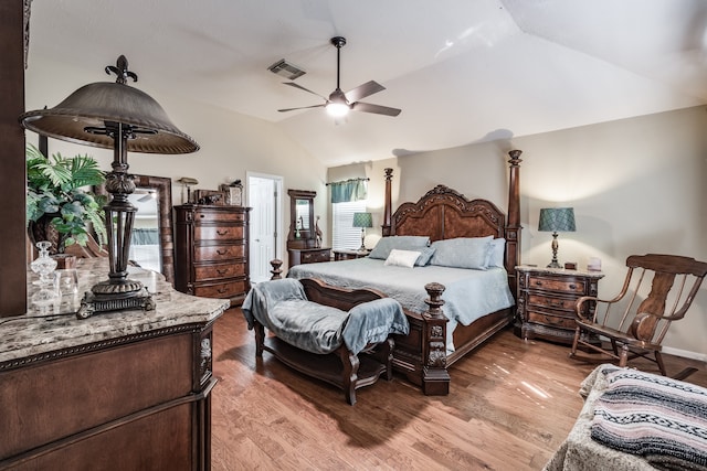 bedroom with lofted ceiling, light hardwood / wood-style flooring, and multiple windows