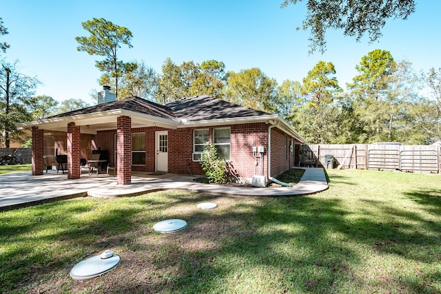 206 Private Road 635, Dayton, TX 77535 - rear view of house with brick siding, a patio area, and a chimney