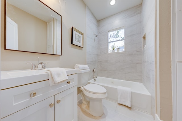 full bathroom with tile patterned flooring, vanity, tiled shower / bath combo, and toilet