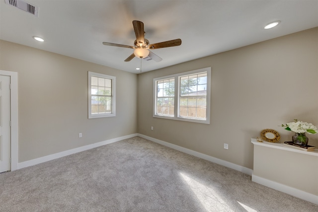 carpeted empty room featuring ceiling fan