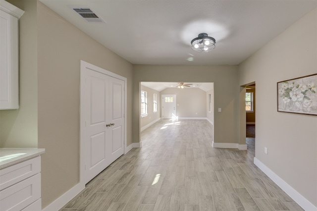 hallway with light hardwood / wood-style flooring