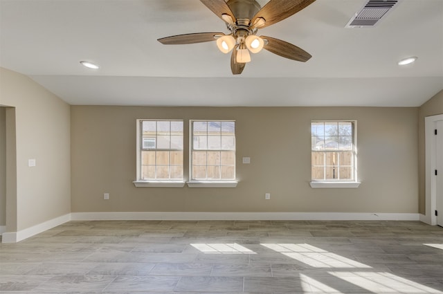 spare room featuring ceiling fan, light hardwood / wood-style flooring, and lofted ceiling