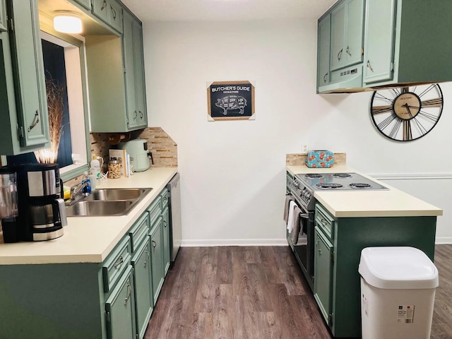 kitchen with sink, tasteful backsplash, electric range oven, dark hardwood / wood-style flooring, and green cabinets