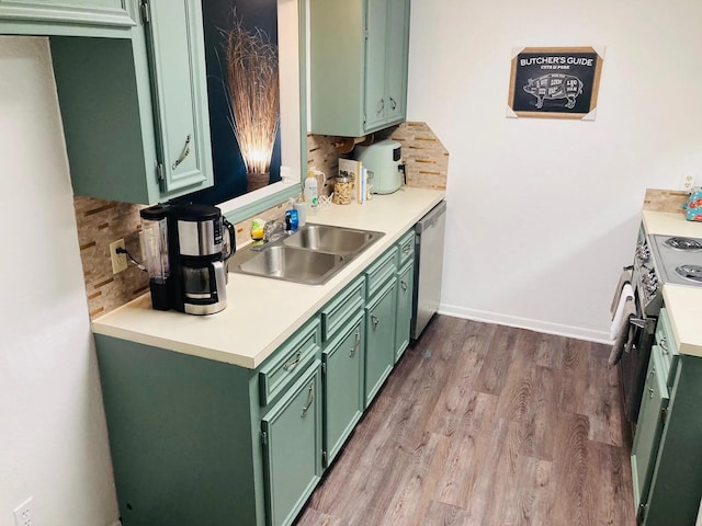 kitchen featuring appliances with stainless steel finishes, sink, and green cabinets