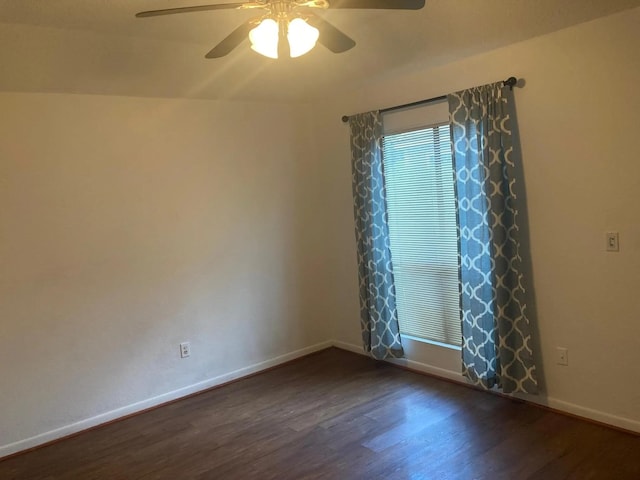 empty room with dark wood-type flooring and ceiling fan