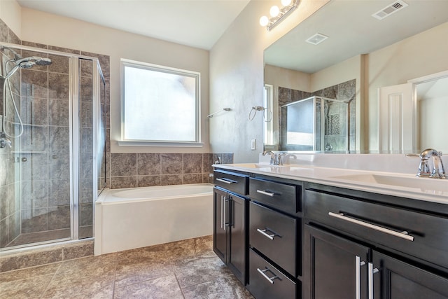 bathroom featuring shower with separate bathtub and vanity