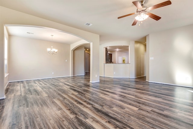 unfurnished living room with ceiling fan with notable chandelier and dark hardwood / wood-style flooring