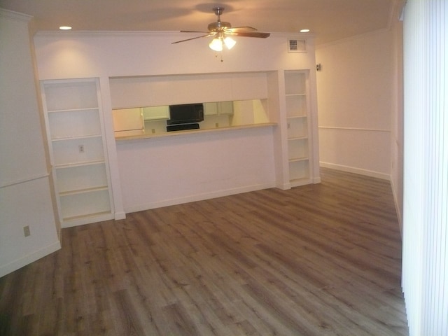 unfurnished living room with crown molding, ceiling fan, and dark wood-type flooring