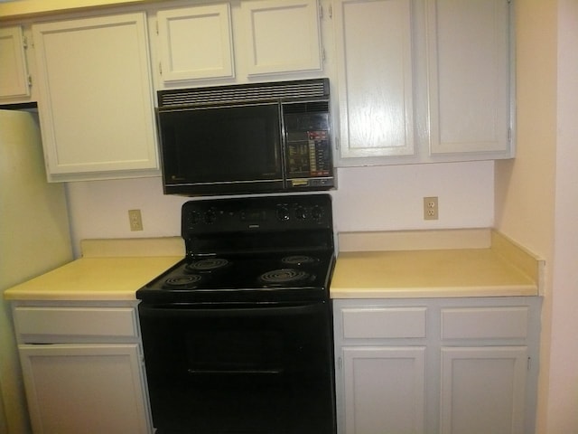 kitchen with white cabinetry and black appliances