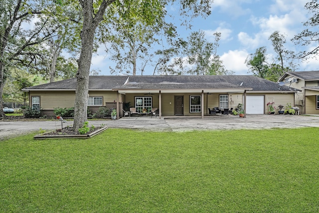 rear view of house with a yard and a garage