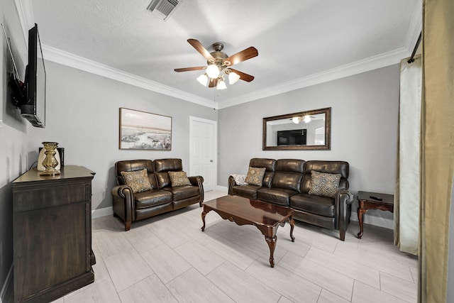 living room featuring ceiling fan, a textured ceiling, and ornamental molding