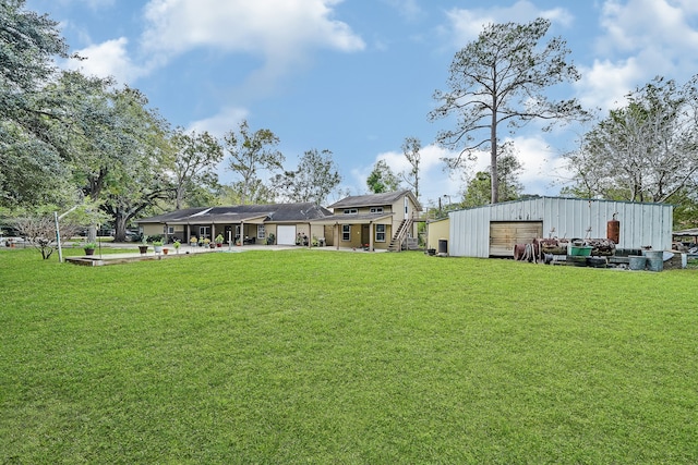 view of yard with a garage and an outdoor structure