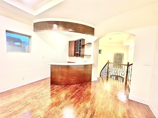 bar with light hardwood / wood-style flooring and crown molding