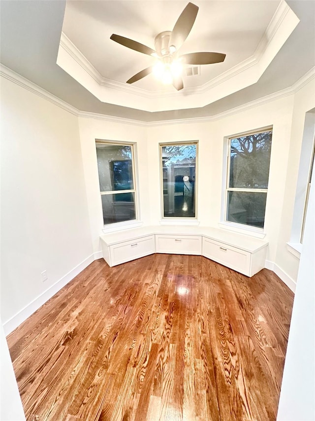 unfurnished room featuring a tray ceiling and crown molding