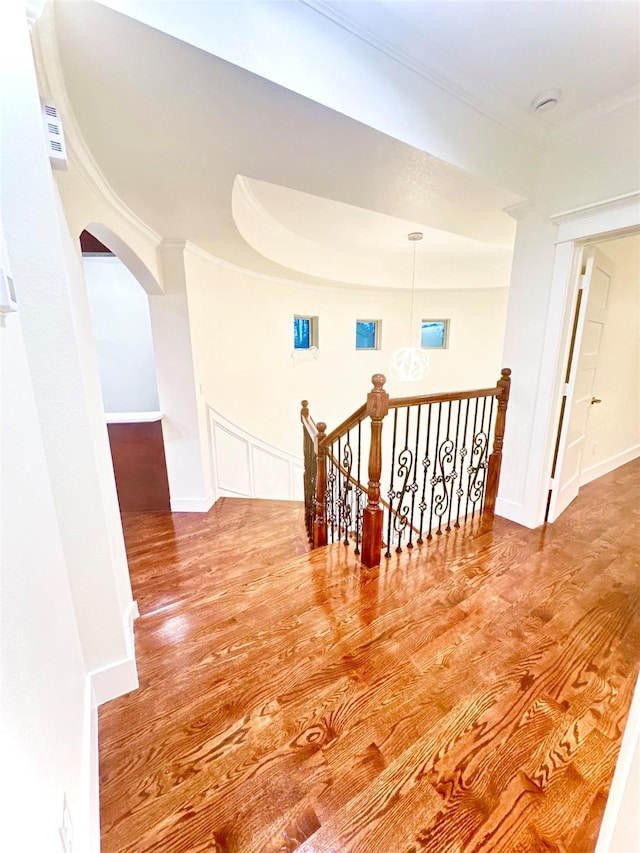 hallway featuring hardwood / wood-style floors and ornamental molding