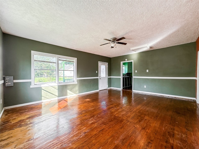 spare room with hardwood / wood-style floors, a textured ceiling, and ceiling fan