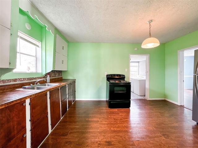 kitchen with pendant lighting, dark hardwood / wood-style floors, black / electric stove, and washer / dryer