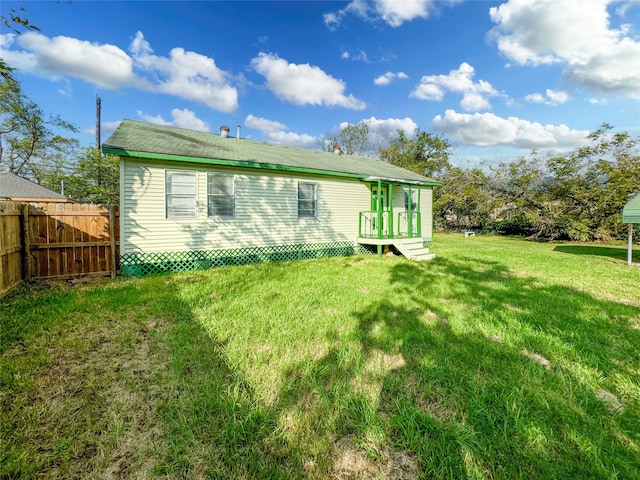 back of house featuring a yard