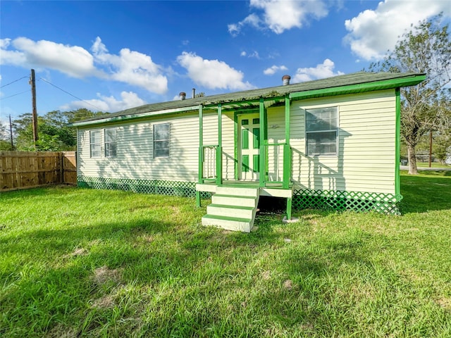 back of house with a yard