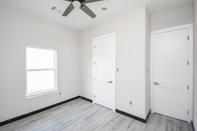 unfurnished bedroom with ceiling fan and light hardwood / wood-style floors