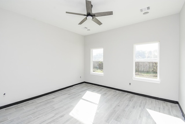 unfurnished room with light hardwood / wood-style flooring, plenty of natural light, and ceiling fan