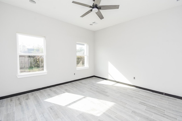 unfurnished room with ceiling fan and light wood-type flooring