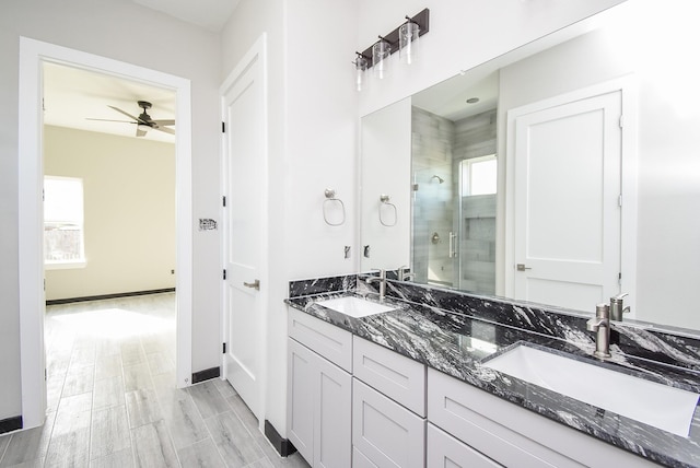 bathroom featuring vanity, hardwood / wood-style flooring, ceiling fan, and a shower with shower door