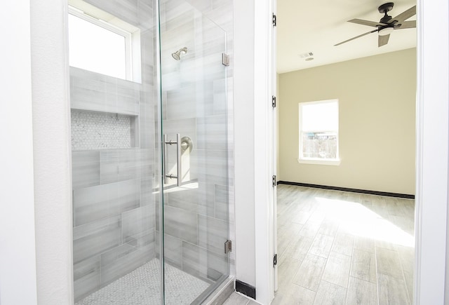 209 Silverleaf Rd, Sweeny, TX 77480 - full bathroom with plenty of natural light, a ceiling fan, a shower stall, and baseboards