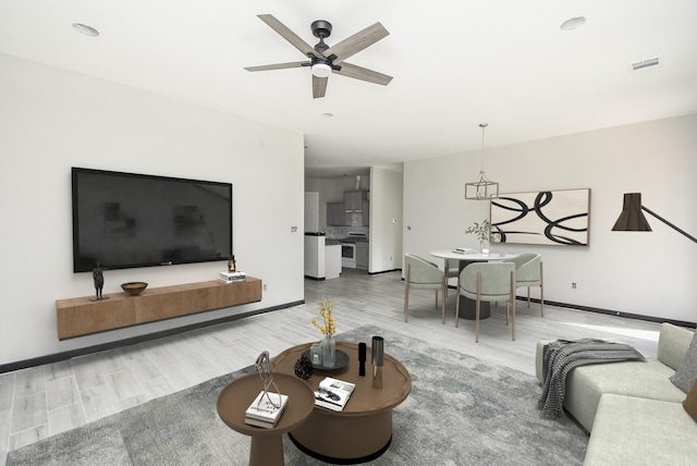 living room featuring hardwood / wood-style flooring and ceiling fan