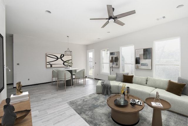 living room featuring ceiling fan and light wood-type flooring