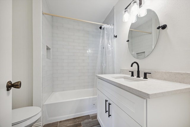 full bathroom with hardwood / wood-style flooring, shower / bath combo, toilet, and vanity