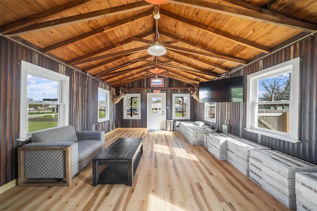 interior space with vaulted ceiling with beams, a healthy amount of sunlight, and wood ceiling