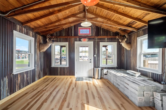 interior space featuring lofted ceiling with beams, light hardwood / wood-style flooring, and wood ceiling