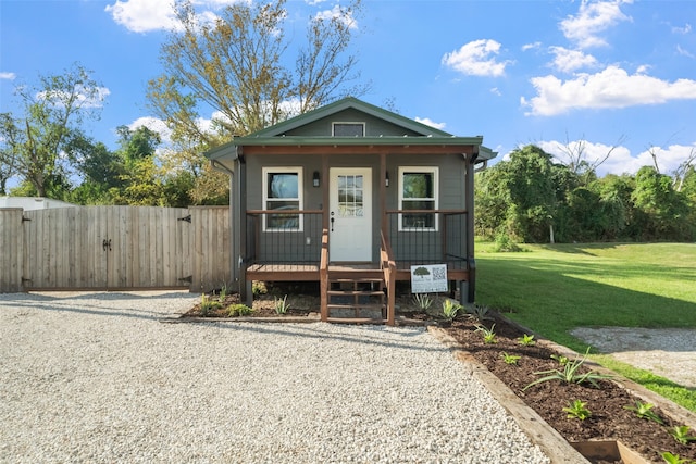 view of front of property with a porch and a front yard